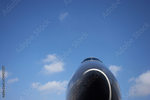 Airplane nose and a clear blue sky photo