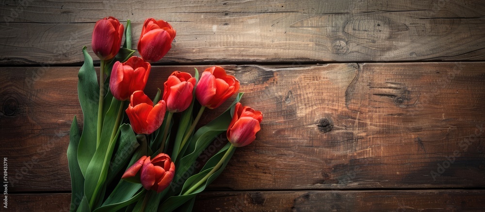 Fresh tulip flowers on wooden table