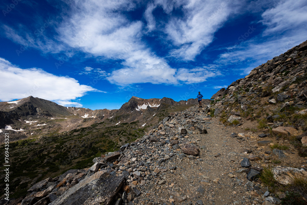 Trail runner on the trail up to Arapahoe Pass in Colorado. Trail runner on the trail up to Arapahoe Pass in Colorado.