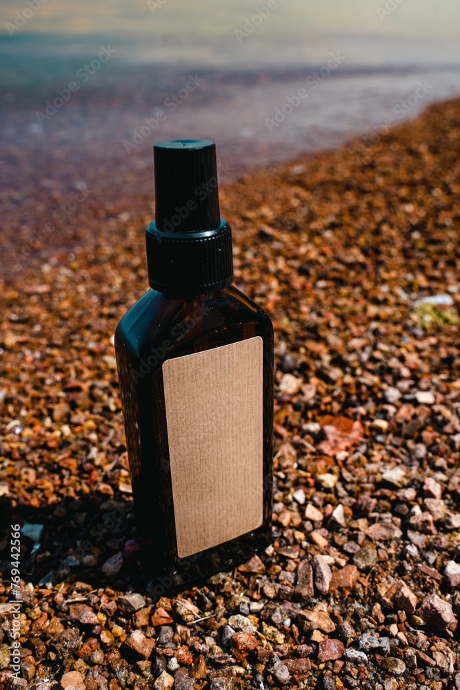 beige brown jar bottle of shampoo cream on the sea on the beach in summer beige brown jar bottle of shampoo cream on the sea on the beach in summer
