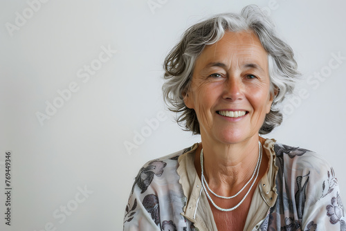 Closeup smiling grandmother , 60+ years, looking at the camera, white background