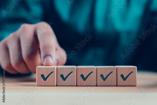 Wooden blocks display checkmarks to summarize task details and compile lists, votes, and to-do lists. Checklists, task lists, lists, and summaries Choose document checklists and online quality assessm