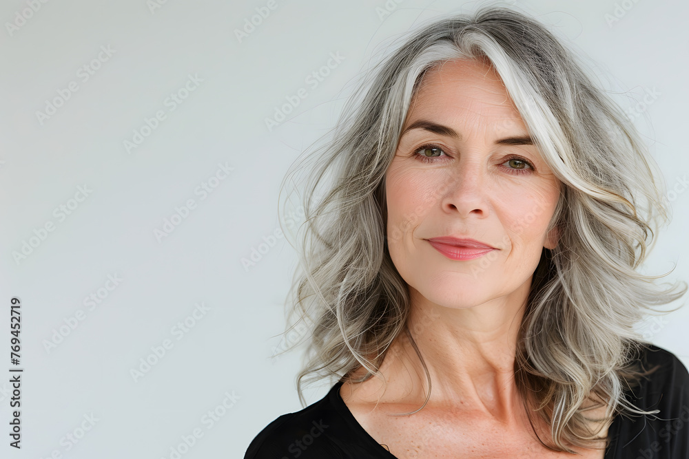 Closeup portrait of Beautiful mature woman, 50+ years, looking at the camera, white background Closeup portrait of Beautiful mature woman, 50+ years, looking at the camera, white background