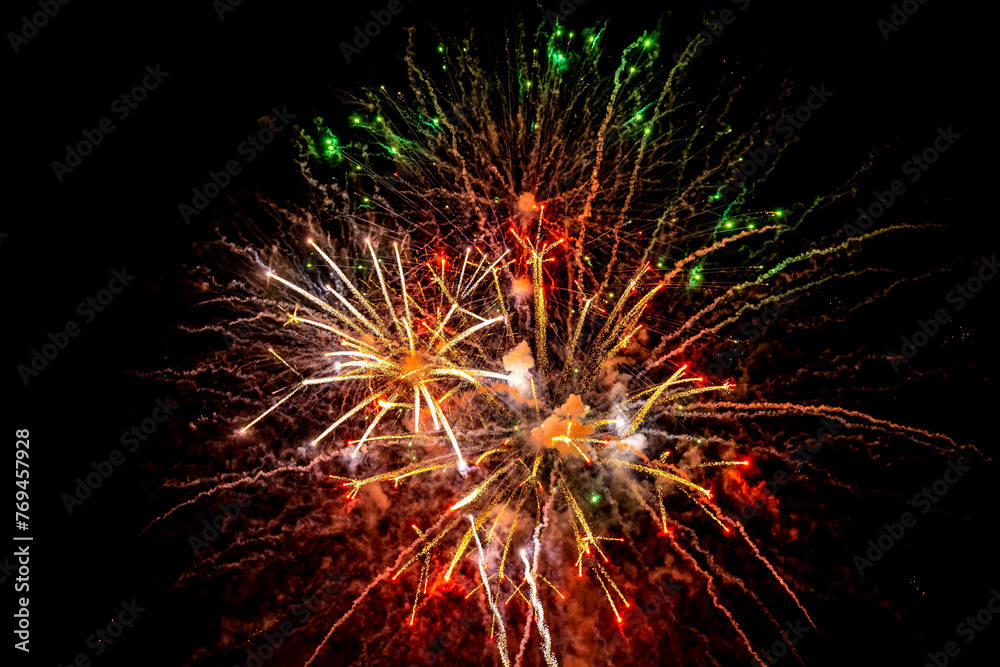 Holiday fireworks explode in the night sky. Selective focus. Holiday fireworks explode in the night sky. Selective focus.
