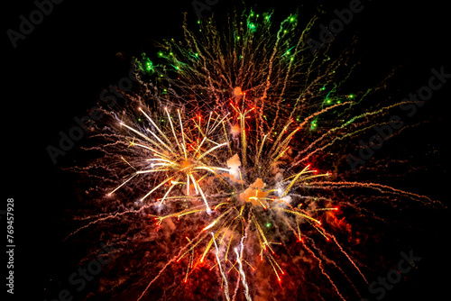 Holiday fireworks explode in the night sky. Selective focus.