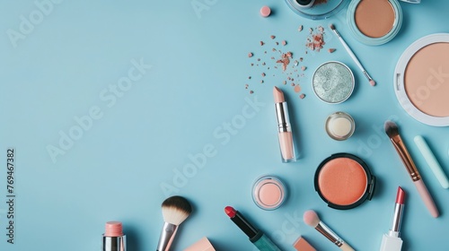 Makeup brushes and cosmetics on blue background. Flat lay, top view.