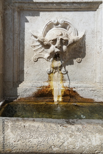 Deatail of the Fountain in Market square in Spoleto, Italy photo