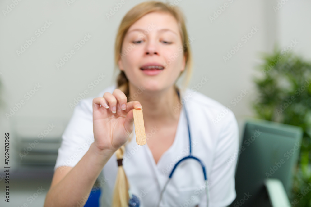 female medicine doctor examining patient tonsils female medicine doctor examining patient tonsils