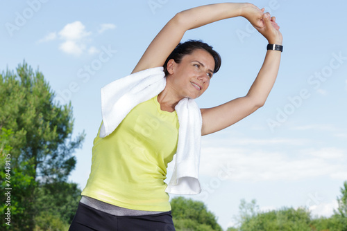 athletic woman stretching legs before run