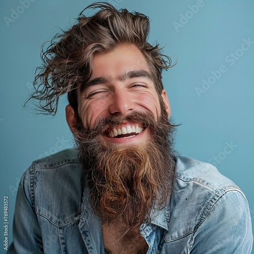 Joyful Hipster Man with Beard Laughing Wholeheartedly photo