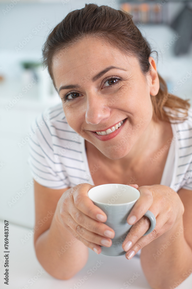 happy attractive middle aged woman drinking coffee happy attractive middle aged woman drinking coffee