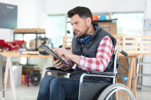 disabled worker in wheelchair in a carpenters workshop