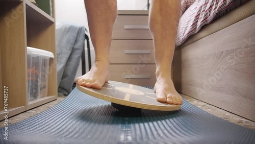 A male tries a balance board at home