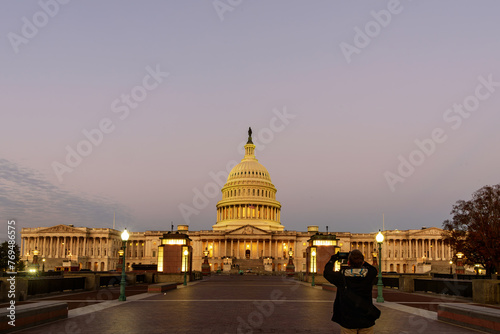 A tourist capturing the Capitol Building in Washington, D.C., at sunrise