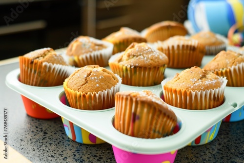 freshly baked muffins cooling in a colorful silicone tray