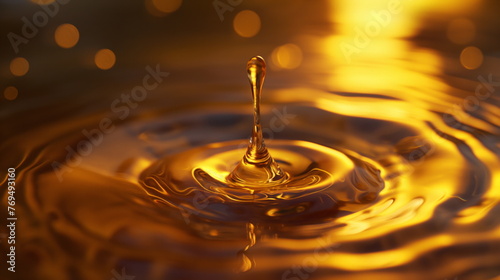 drop of water captured just as its about to hit a golden-hued liquid surface  reflecting the warm light