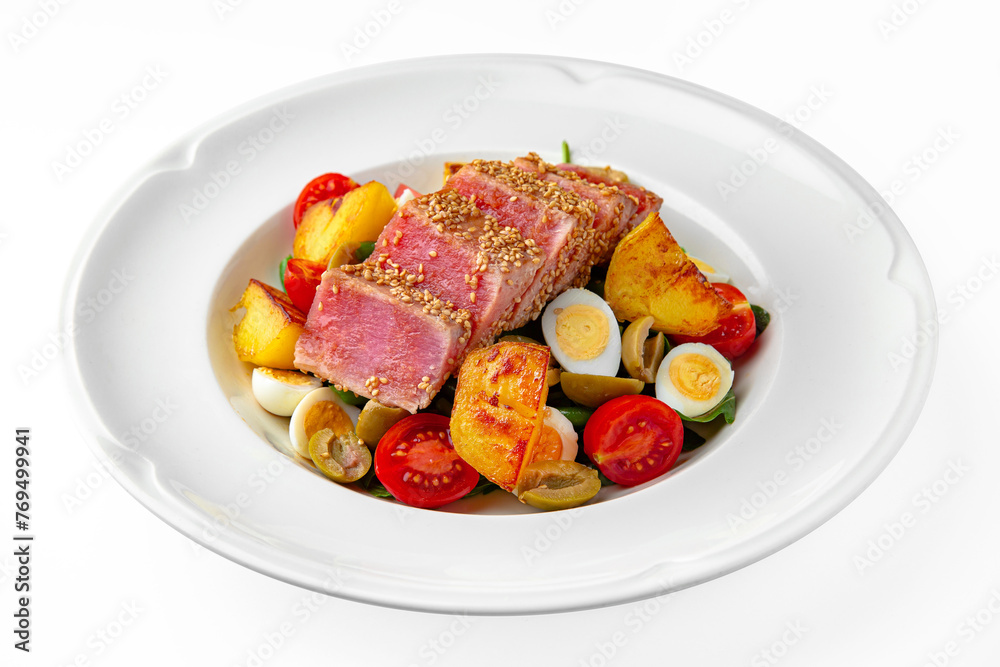 Light diet salad. Tuna seared in sesame seeds with vegetables and herbs on a white plate. Banquet festive dishes. Gourmet restaurant menu. White background. Light diet salad. Tuna seared in sesame seeds with vegetables and herbs on a white plate. Banquet festive dishes. Gourmet restaurant menu. White background.