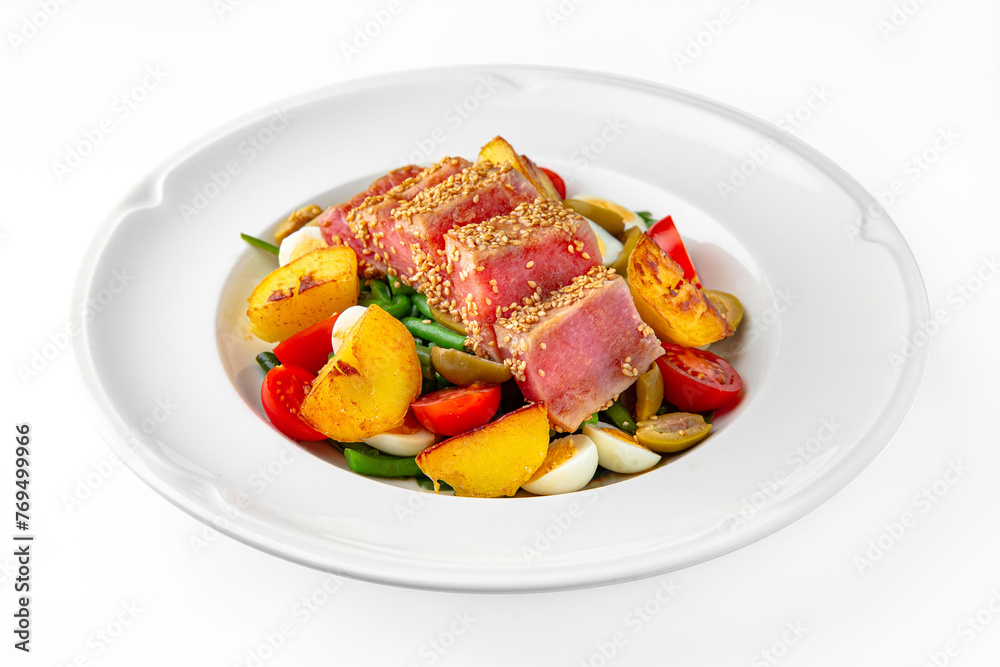 Light diet salad. Tuna seared in sesame seeds with vegetables and herbs on a white plate. Banquet festive dishes. Gourmet restaurant menu. White background. Light diet salad. Tuna seared in sesame seeds with vegetables and herbs on a white plate. Banquet festive dishes. Gourmet restaurant menu. White background.