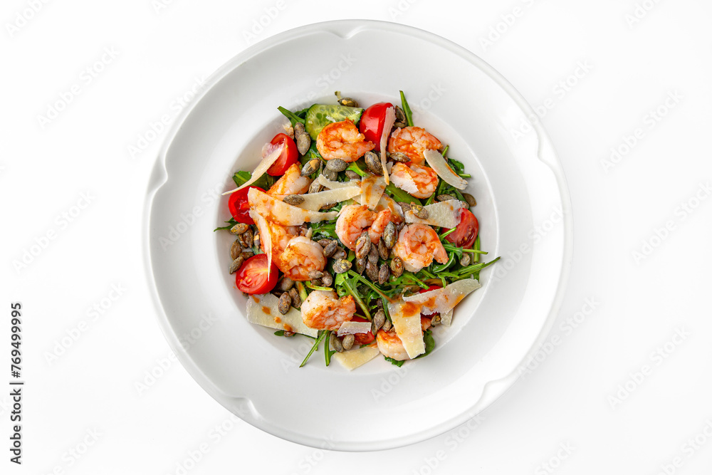 Easy diet salad with shrimp, pumpkin seeds and greens on a white plate. Banquet festive dishes. Gourmet restaurant menu. White background. Easy diet salad with shrimp, pumpkin seeds and greens on a white plate. Banquet festive dishes. Gourmet restaurant menu. White background.