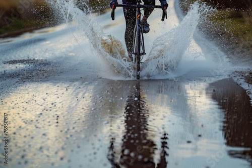 cyclist riding through a puddle, water spraying out