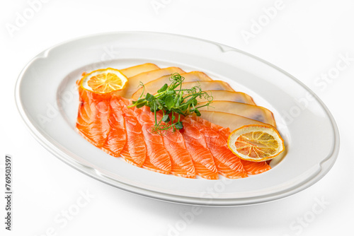 Slices of delicatessen salmon and buttery salted fish on a white plate. Banquet festive dishes. Gourmet restaurant menu. White background.