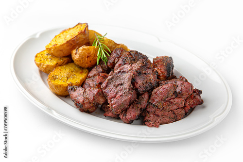 Beef or pork kebab with baked potatoes on a white plate. Banquet festive dishes. Gourmet restaurant menu. White background.