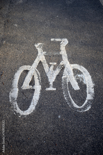 Weathered Symbol of Bicycle on Tarmac Road in Close Up