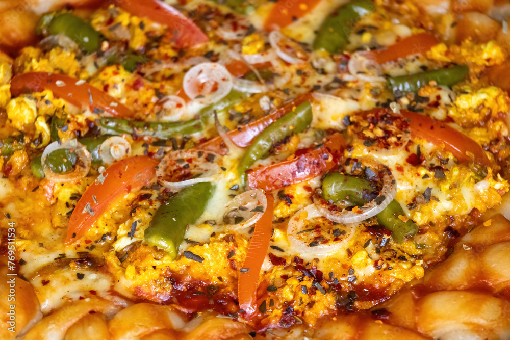 Tasty egg pizza with cheese, tomatoes, chili flakes, onions, green peppers, white sauce, and oregano powder on pizza. Healthy homemade food closeup view. Tasty egg pizza with cheese, tomatoes, chili flakes, onions, green peppers, white sauce, and oregano powder on pizza. Healthy homemade food closeup view.