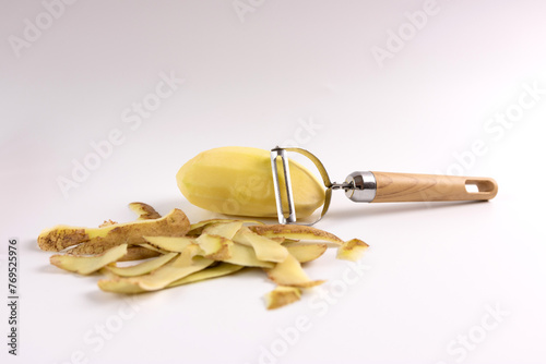 Wallpaper Mural Peeled raw potato and shell and knife for peeling on white background. Torontodigital.ca