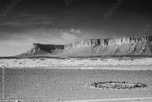 Infrared black and white photography of Sahara desert and Jbel Bani mountains on a way to Foumz Guid in Morocco. 850 nm filter. Rocky circle photo