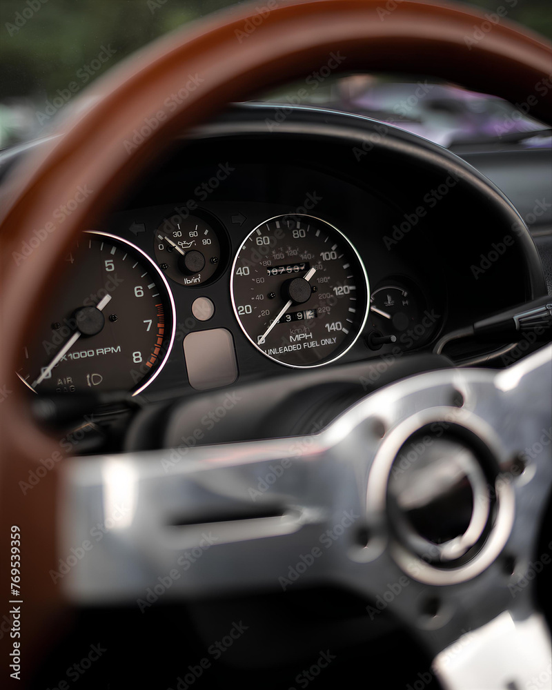 Classic sports car dashboard close up. Speedometer and tachometer.