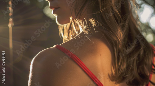 Golden Hour Glow: Close-Up of Woman's Shoulder with Goosebumps in the Warm Sunset Light