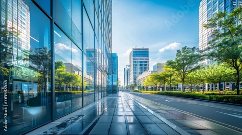 Modern buildings and a pristine road mirrored perfectly on a glass wall