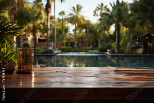 Wooden table pool bokeh background  empty wood desk product display mockup with blurry tropical hotel resort abstract poolside summer travel backdrop advertising presentation. Mock up  copy space .