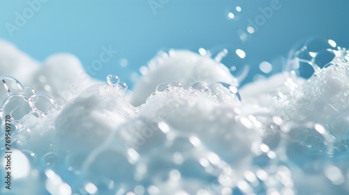 A close-up image of white soap bubbles forming a luscious foam against a vivid blue background