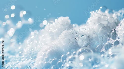 A close-up image of white soap bubbles forming a luscious foam against a vivid blue background