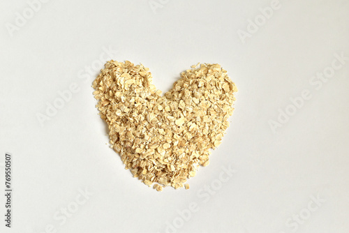 Rolled oat flakes are laid out in a heart shape.