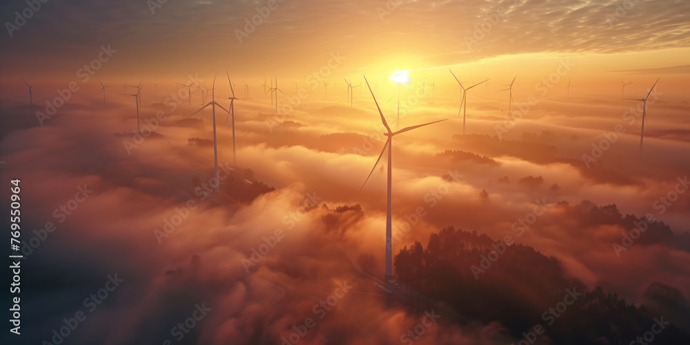 Rows of wind turbines generating power in scenic evening scenery at winter. Windmills generating green energy on background of blue evening sky.