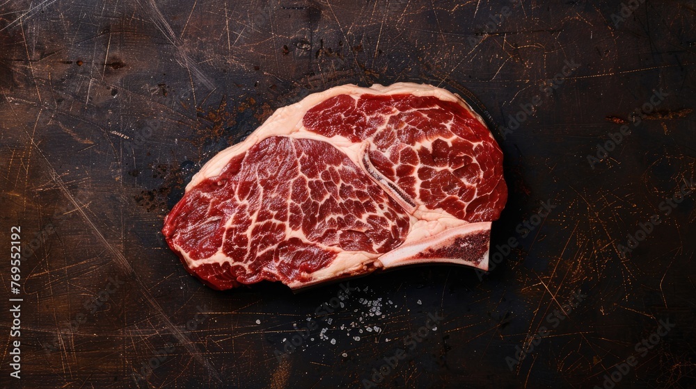 A piece of meat with a lot of fat on it. The meat is brown and has a lot of marbling