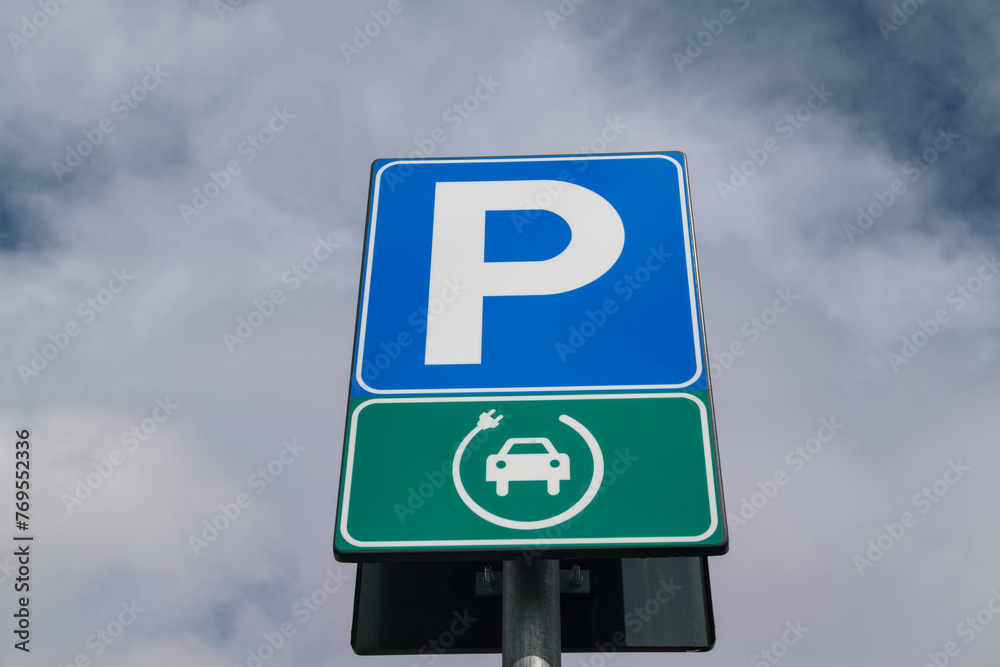 Road signs for electric vehicle charging. sign with parking symbol and electric cable, for a space reserved for electric cars. eco urban mobility Road signs for electric vehicle charging. sign with parking symbol and electric cable, for a space reserved for electric cars. eco urban mobility