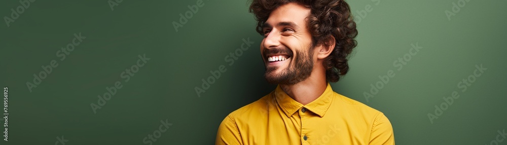 Fototapeta premium Cheerful male, solid color background, eyelevel shot, bright mood, space on the right
