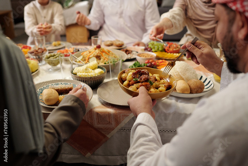 Unrecognizable Muslim Family Having Dinner