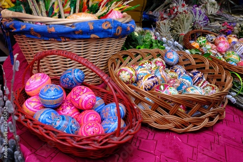 Beautiful handmade colorful Easter eggs in a basket and Easter palms on stall during fier. Kurpie, Poland  © Iwona