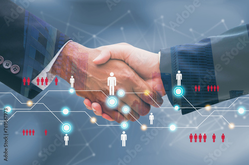 Close up of businessmen shaking hands with connected digital people team icons . Digital network, online community and social media concept.