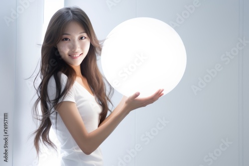 Cute woman with LED round flash lamp in white glow. Moon lamp turn on and hold by two hands. Generative AI. © Surachetsh