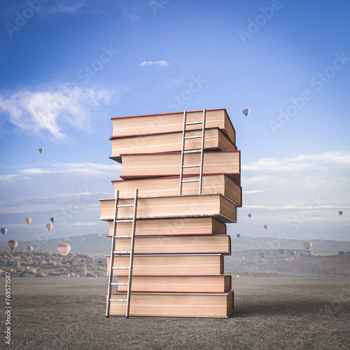 stack of books with ladders, background with hot air balloons.