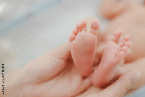 Tender Newborn Toes.  A heartwarming close-up of a parent cradling their baby’s delicate feet, radiating love and connection © Gether.C