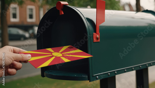 Close-up of person putting on letters with flag Republic of Macedonia in mailbox