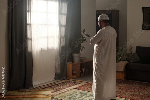 Muslim Man In White Thobe Praying Salat photo