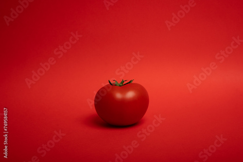 red tomato on a red background © Andrei